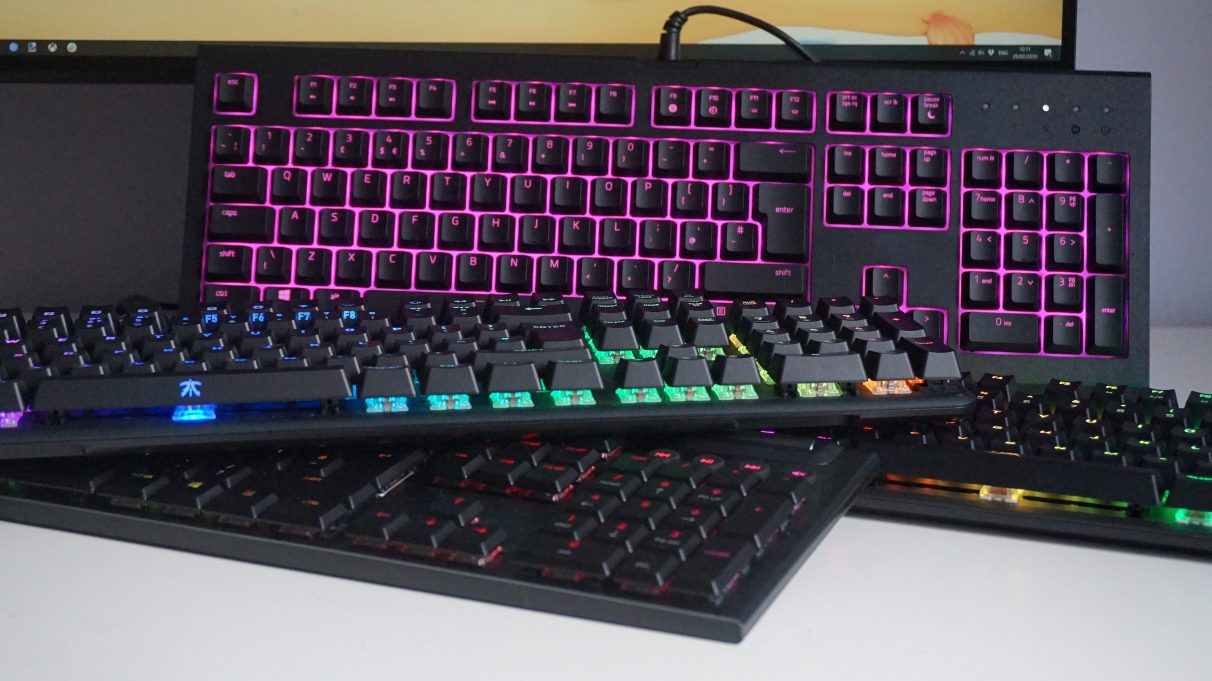 A collection of gaming keyboards on a table.