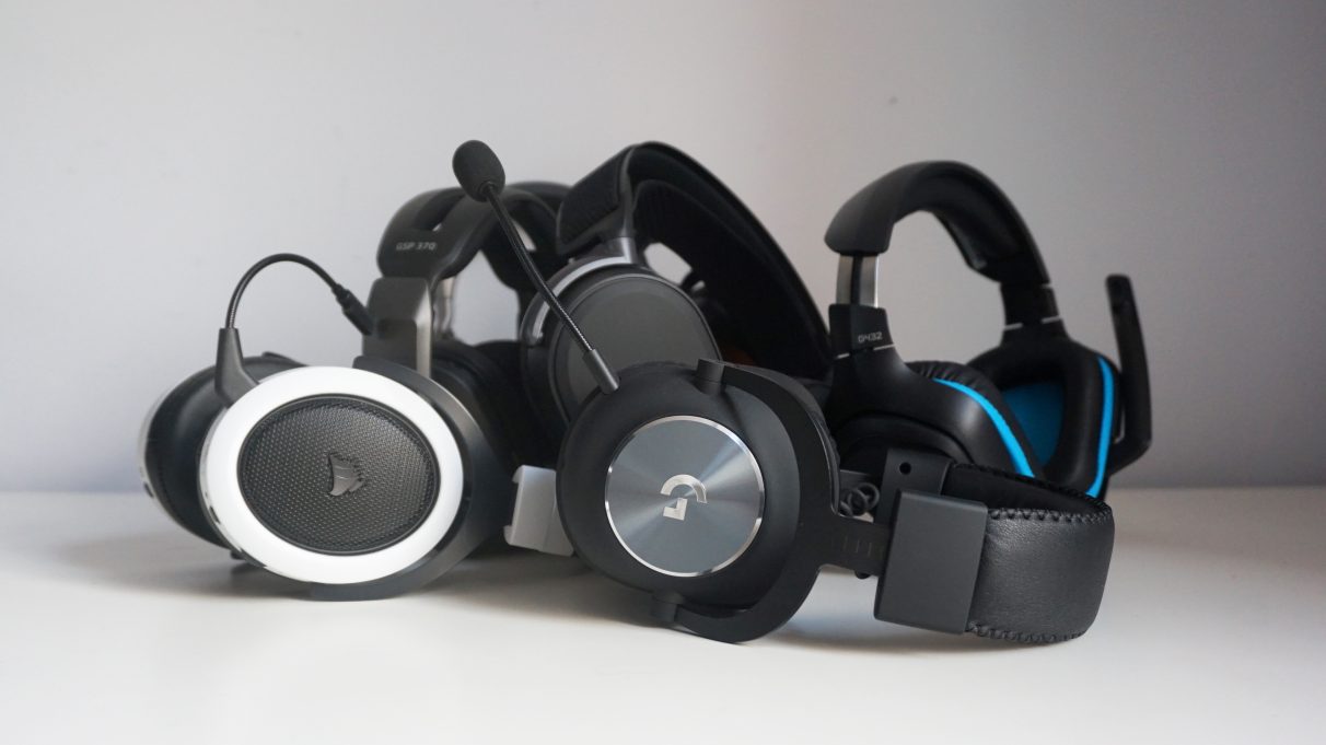 A collection of gaming headsets on a table.